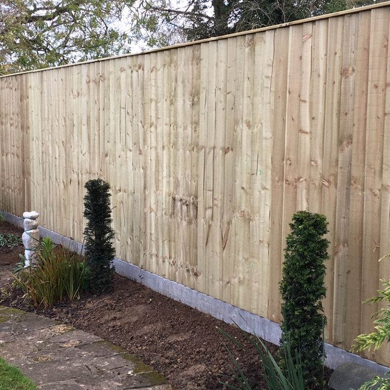 Closed board fencing with concrete posts and gravel boards.